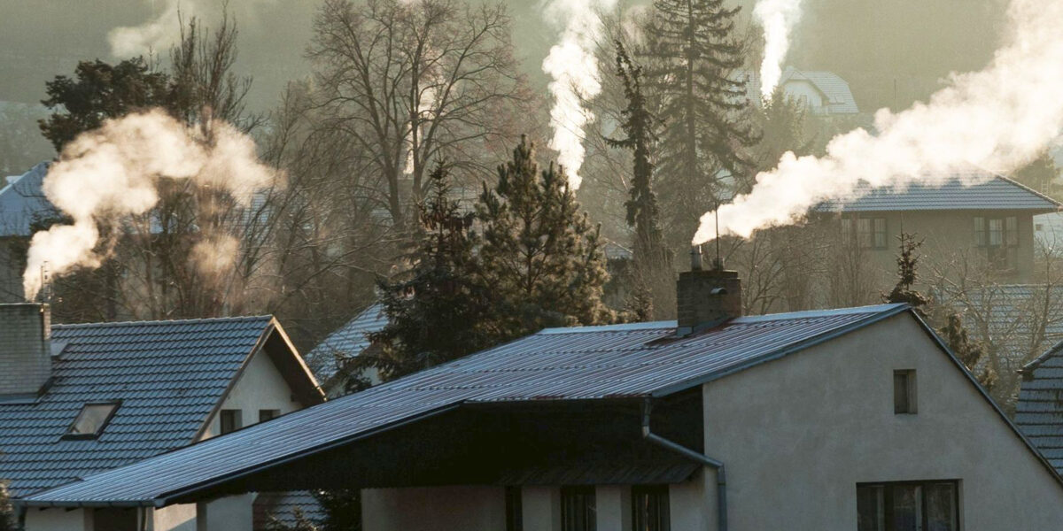 Smoking chimney smoke pollution, small house town in Europe